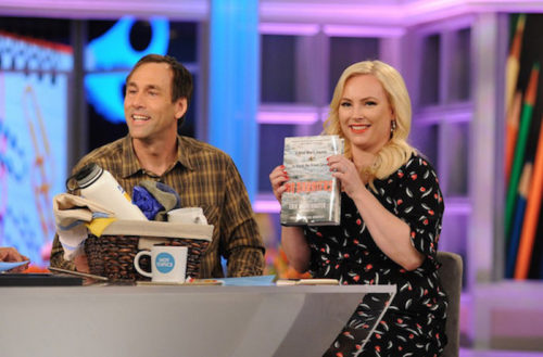 a photo of erik weihenmayer on the tv show the view with megan mccain who is holding up a copy of his book no barriers
