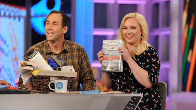 a photo of erik weihenmayer on the tv show the view with megan mccain who is holding up a copy of his book no barriers