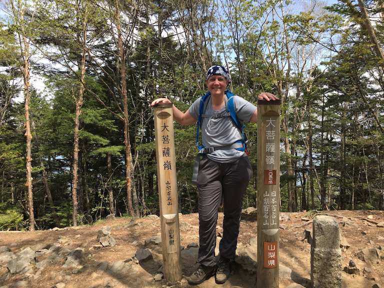 a photo of susan on the summit of mount daibosatsu her second mountain which she climbed almost a month to the day after finishing chemotherapy for breast cancer