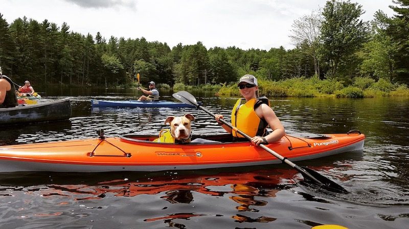 a photo of nerissa kayaking with her dog