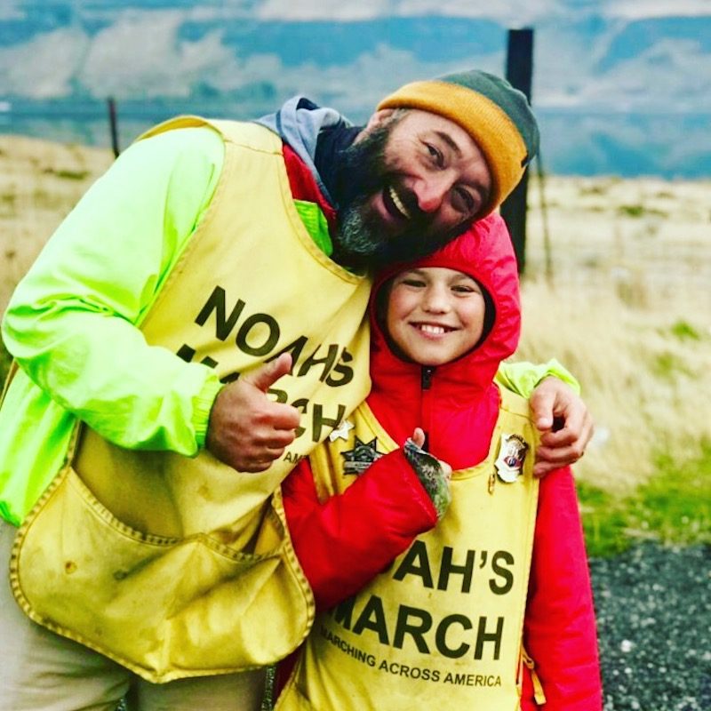a photo of noah and his dad robert barnes on their march across the usa