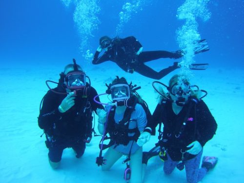a photo of jody and his family posing for a photo underwater