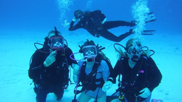 a photo of jody and his family posing for a photo underwater