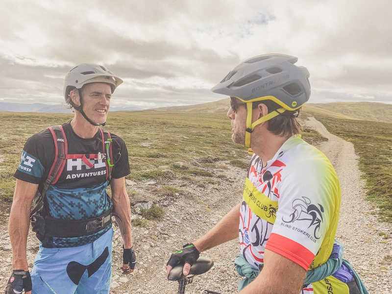 Erik and guide stop to chat about the route, landscape, and history, of Scotland. Credit: Daniel Bedell. 