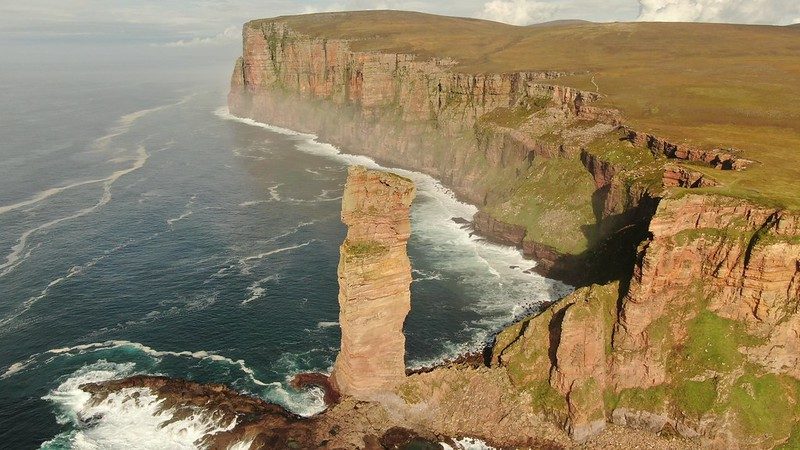 The Old Man of Hoy rising dramatically from the sweeping Scottish coastline. Credit: Keith Patridge