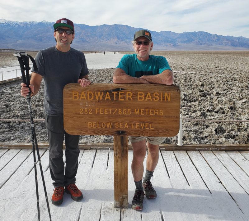 Erik and Bob standing beside a sign that reads: Badwater Basin, 282 Feet/85.5 Meters Below Sea Level.