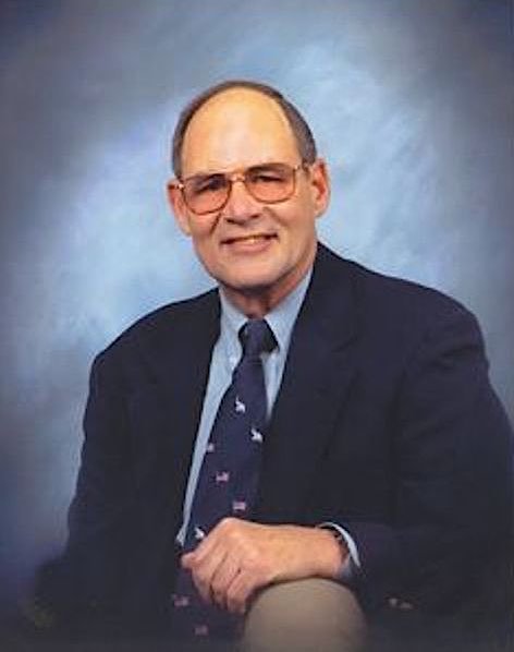Ed Weihemayer wearing a suit and wire-rimmed glasses