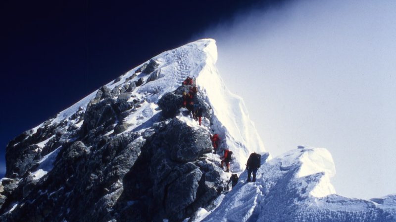 Erik Weihenmayer and his rope team approaching the windblown summit of Mount Everest, 2001.