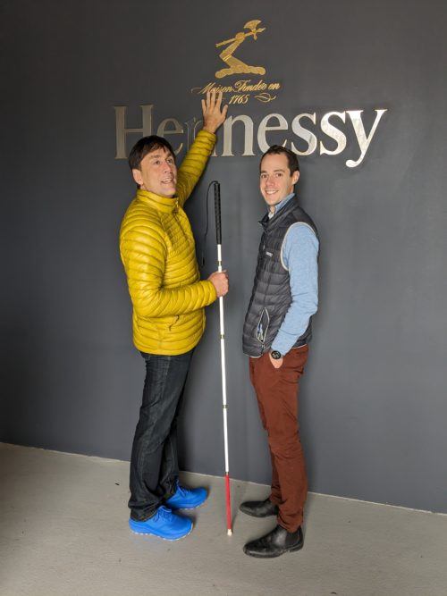 Me touching the Hennessy logo while standing next to one of the wonderful employees who showed us around.